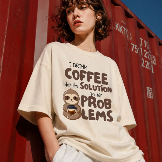 Person wearing a t-shirt with a sloth graphic and text in front of a red shipping container.