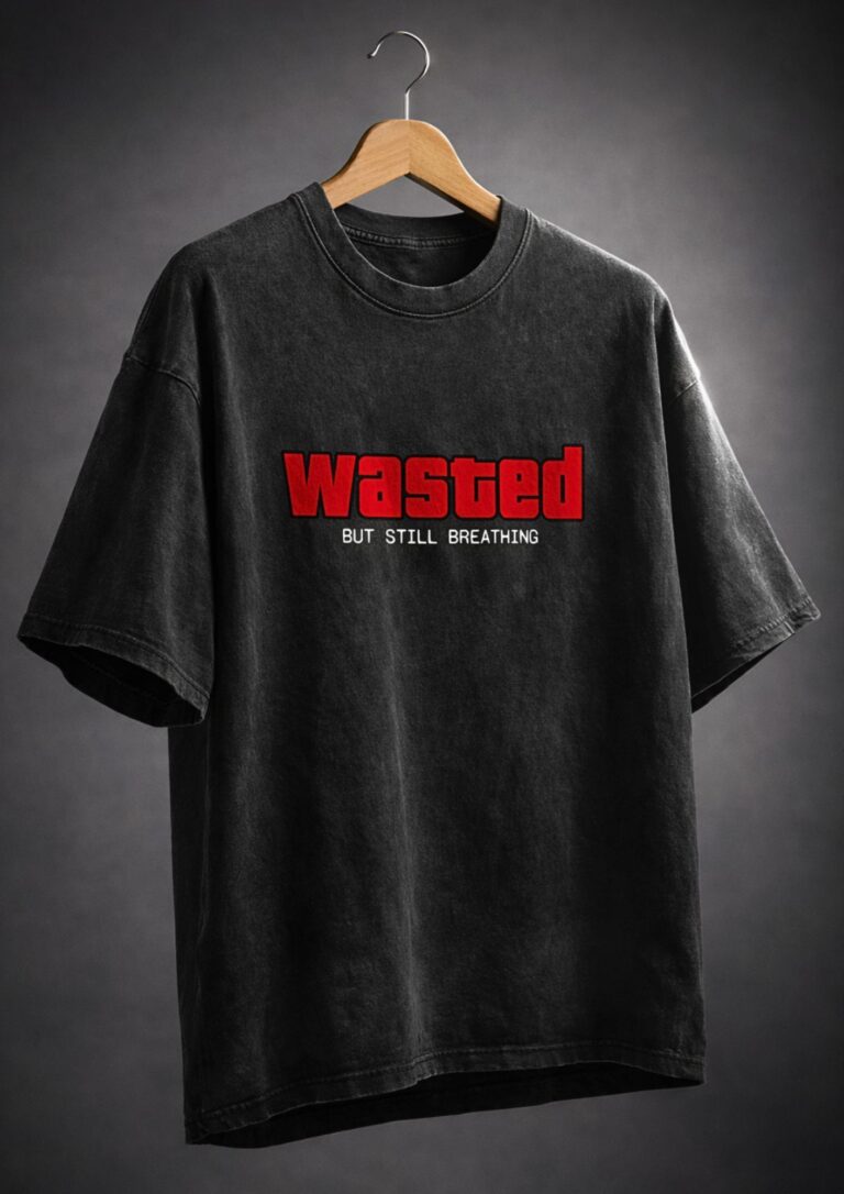 Unisex black acid wash oversized graphic t-shirt with bold red "Wasted But Still Breathing" slogan print, 240gsm heavyweight cotton, no shrink no fade